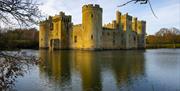 National Trust Bodiam Castle surrounded by water in the sunset