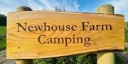 Newhouse Farm Camping wooden sign