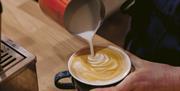 Latte art created over specialty coffee.