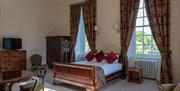 castle room with big windows and period furniture