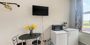 studio room with tables and microwave and tv