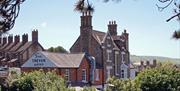 View of the pub from afar - show the writing on its wall The Trevor Arms.