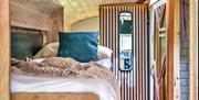 Bedroom inside the converted school bus glamping accommodation in Sussex