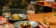 wine being poured at terra restaurant for a romantic evening meal or overnight stay in Tottington Manor, AA Rosette Dining for celebrations and restau