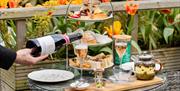 afternoon tea at TERRA Restaurant at Tottington Manor, with a glass of Ridgeview Bloomsbury English Sparkling Wine, Perfect in the summer sunshine in