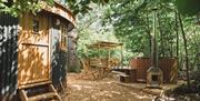 The Roundhouse: a woodland cabin for couples, with pretty outdoor covered dining deck, firepit and wood fired hot tub