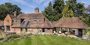 view of the back of the house with lawns and outdoor seating areas