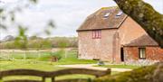 An old sussex granary looking through Oak tree branches