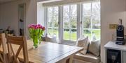 Dining table in nook area overlooking pond