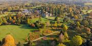 drone image of Wakehurst including the Mansion and surrounding lawns, pond and trees