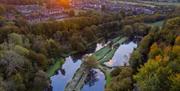 Aerial view of Chalk Farm trout fishery lakes with views of Arundel Cathedral and Castle in the background.