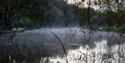 Aerial view of Chalk Farm trout fishery lakes on a misty morning