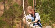 Girl on Bosun's Chair crossing at Go Ape