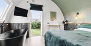 A bedroom at Nestled on the farm including a freestanding bath
