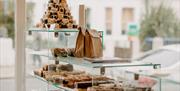 A view from behind our counter. Glass cabinets filled with brownies, blondies and brookies.