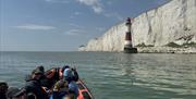 View of beachy head lighthouse from the water in a rib boat