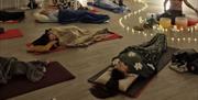 People lying on the floor enjoying a sound bath meditation