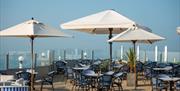 the terrace view of tables overlooking the sea