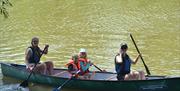 a family in a canoe on the river