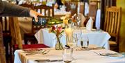 stopham vineyard, wine bottle pouring into glass in restaurant