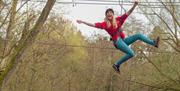 Woman on zipline at Go Ape Crawley