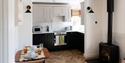 Kitchen diner with table big enough for two and a wood fired stove