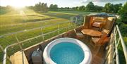 a view from the roof of a converted bus - with splash pool table and chairs on the top deck