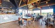 scene of the inside of the cafe with chairs and tables