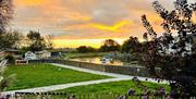 Sunrise over the tranquil River Arun in Arundel, with soft light reflecting on the water near Arden House B&B.