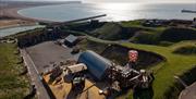 aerial view of the forts outdoor childrens play area with the sea and cliffs in the distance