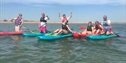 group session on paddleboards - people looking happy