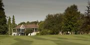 view of the club house and golf course