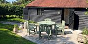 Outside tabel and chairs in front of the Dairy in secluded garden.
