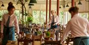inside the restaurant with staff laying the table