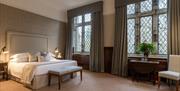 spacious bedroom with double bed and large windows