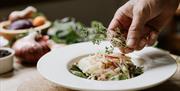 A plate of food being garnished